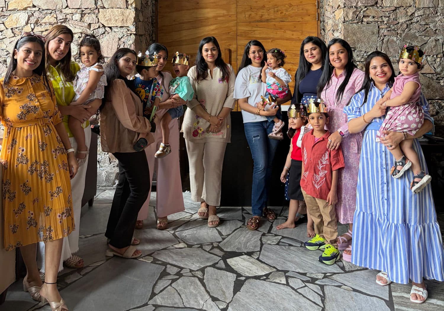 Moms and their little ones wearing paper crowns at a Play and Pause playdate in Jaipur